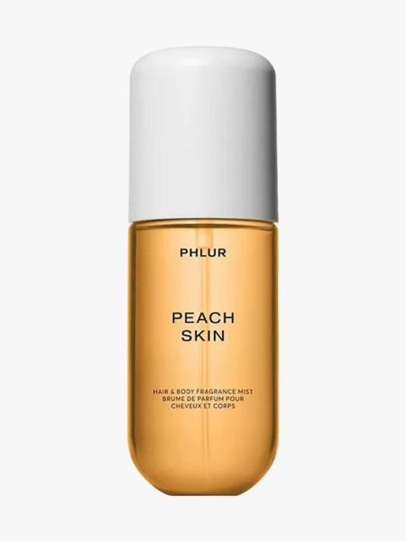 Peach colored bottle of PLHUR Peach Skin Hair & Body Fragrance Mist with white cap on light gray background