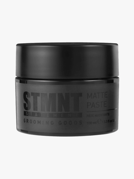 STMNT Matte Paste in branded tub component on a light gray background