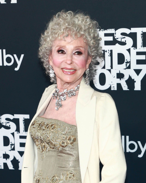 Rita Moreno wearing a beige strapless embroidered dress and cream jacket