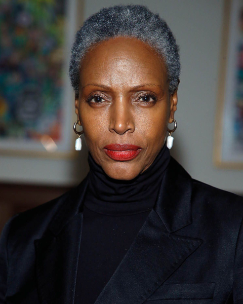 Coco Mitchell in a black turtleneck and jacket
