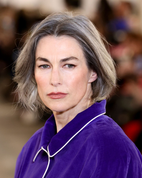 Model wearing purple shirt with gray bob hairstyle